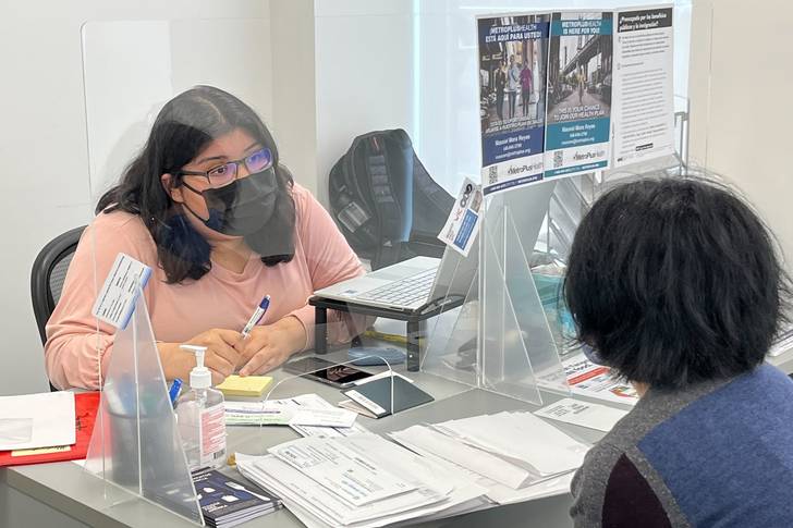 Benefit Access Specialist Jennifer Pereda talks to Blanca Lopez about getting recertified for SNAP at the Hunger Free America office in the Bronx.